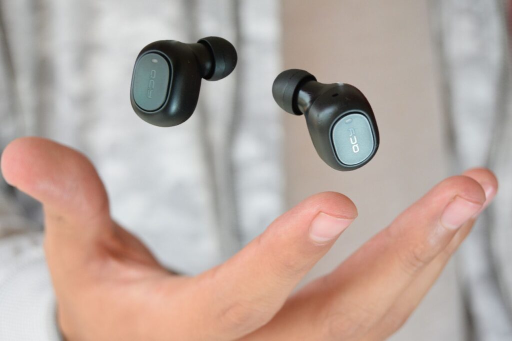Woman tossing earbuds