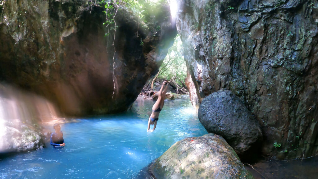 Diving off rock into water