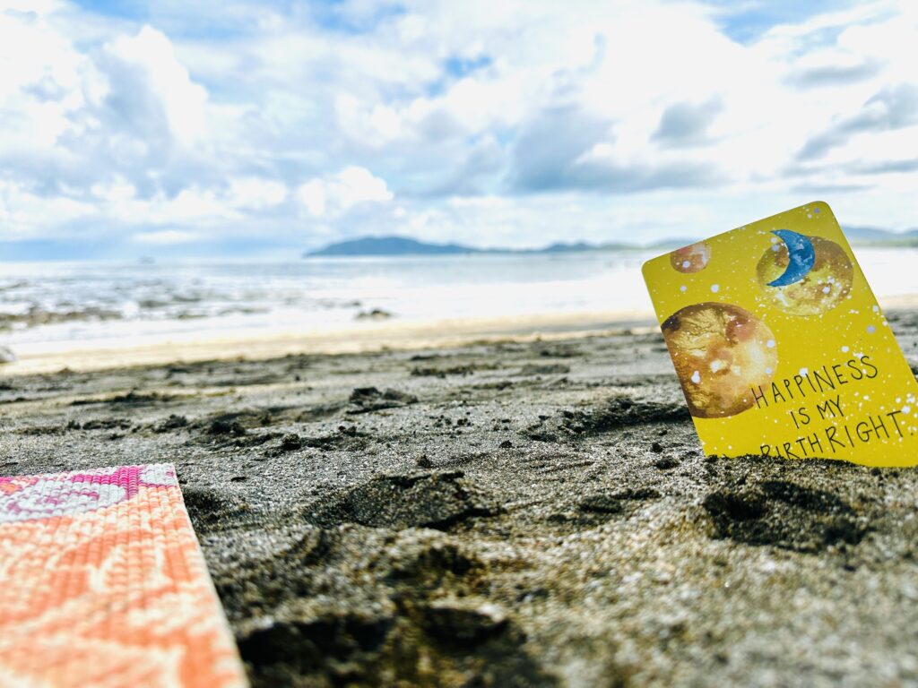 Happiness in my birthright card in sand