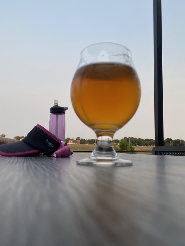 NA beer in glass with workout gear in the background