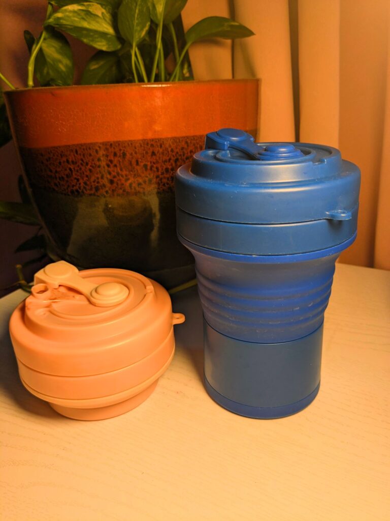 Pink collapsed and blue standing collapsible coffee mugs