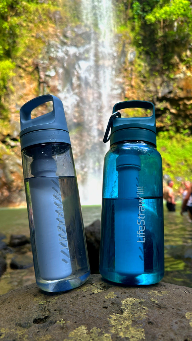 Life Straw Water Bottles in front of waterfall