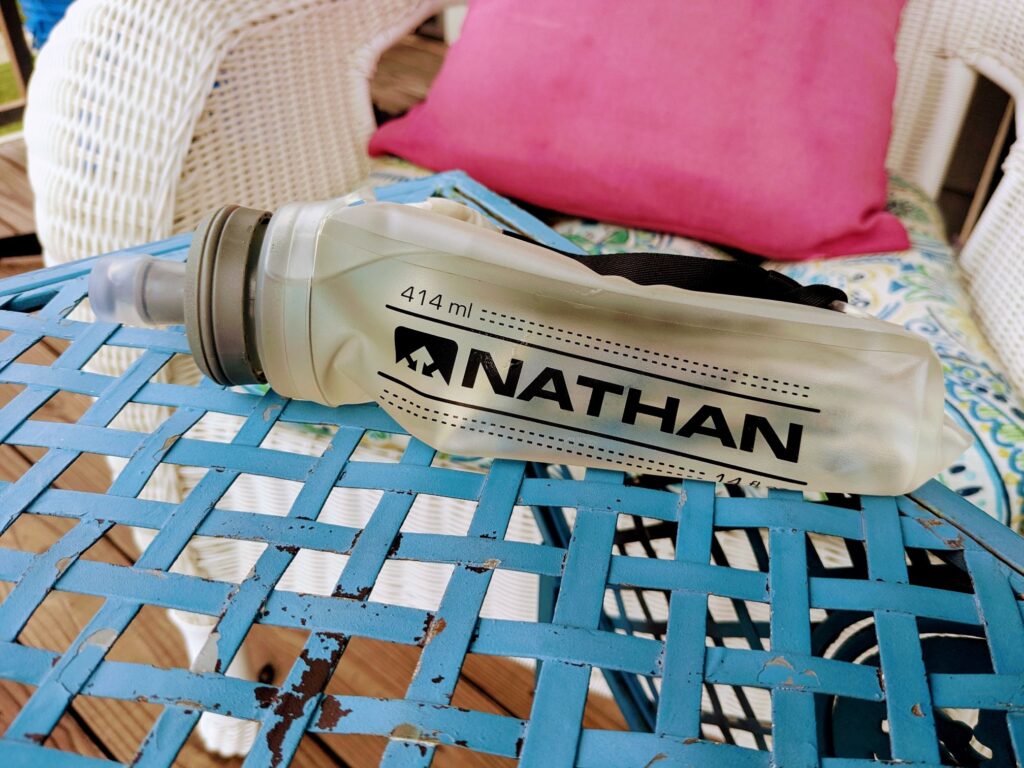 Nathan collapsible water bottle setting on an outdoor table