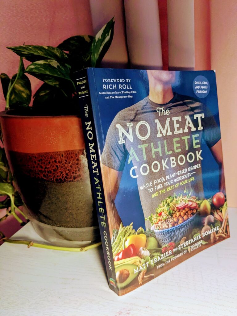 No Meat Athlete Book leaned against a potted plant