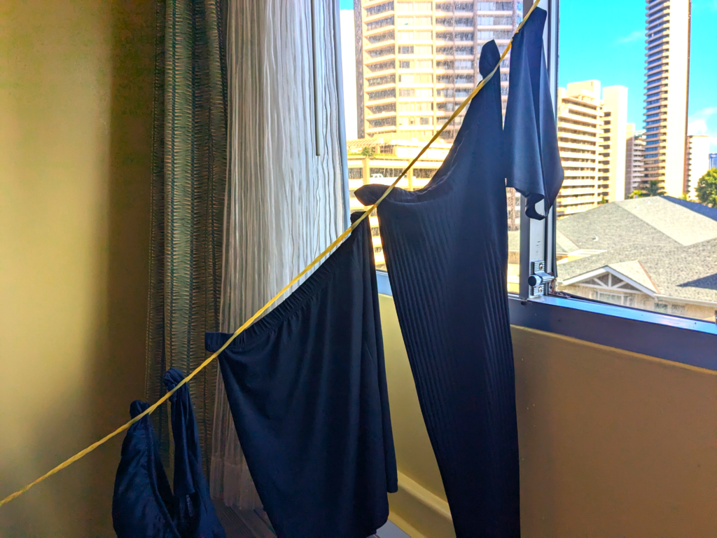 Clothes on clothesline in hotel room