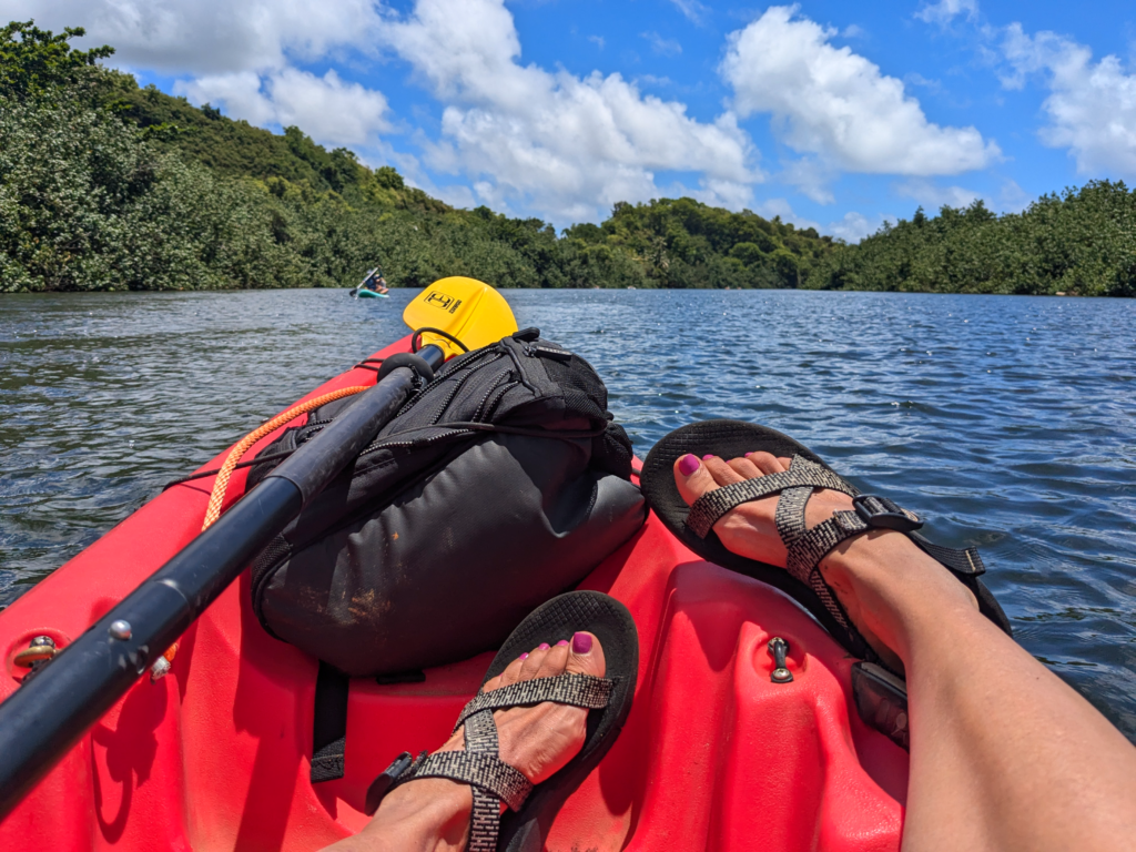 Woman wearing chacos in a kayak