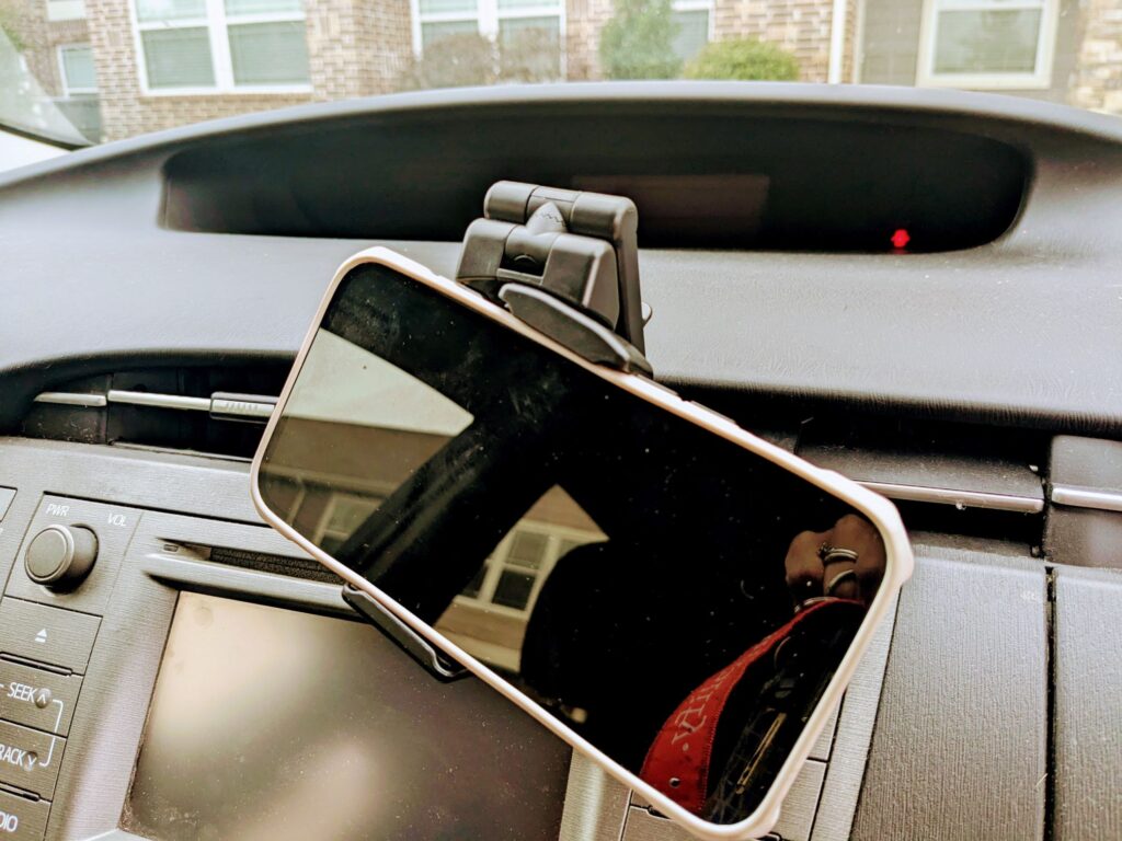 Phone mounted in phone clip inside car