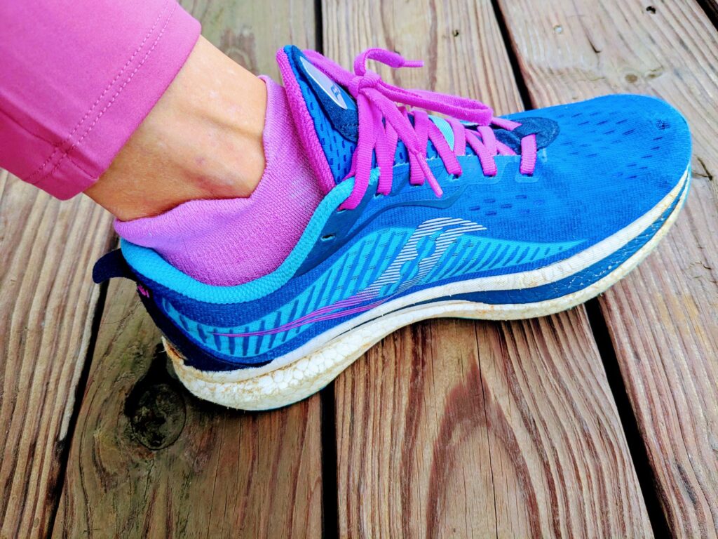 Blue and pink Saucony Endorphin running shoe on woman's foot