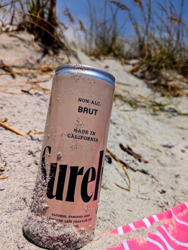 Can of Surely Brut on the beach